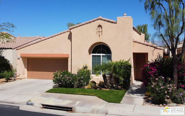 mediterranean / spanish-style home with a garage