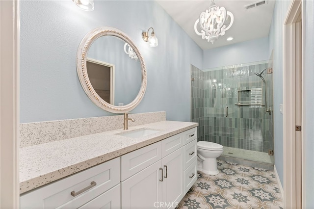 bathroom featuring a shower with door, vanity, a notable chandelier, tile patterned floors, and toilet