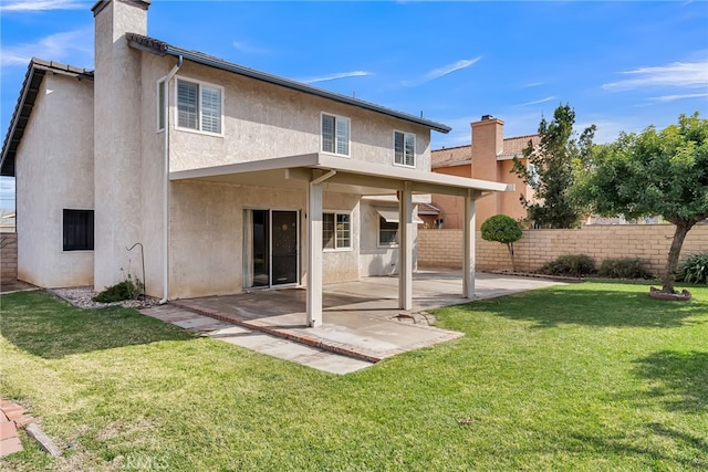 back of property featuring a yard and a patio