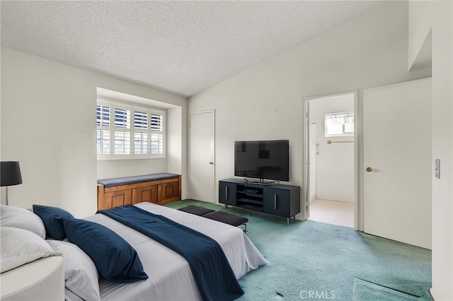 carpeted bedroom featuring vaulted ceiling and a textured ceiling