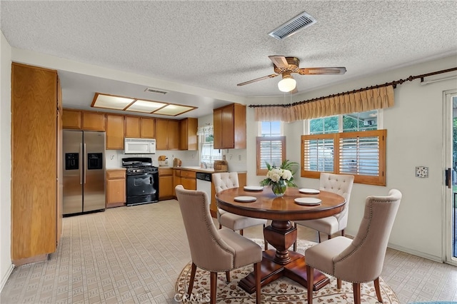 dining room featuring a textured ceiling and ceiling fan