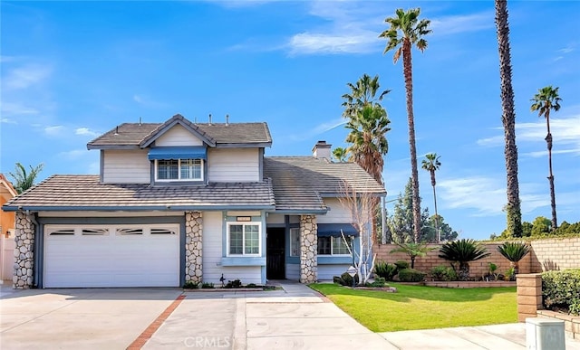 view of front of house featuring a garage and a front yard