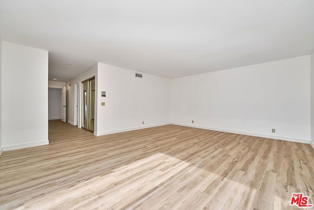 unfurnished room featuring light hardwood / wood-style floors