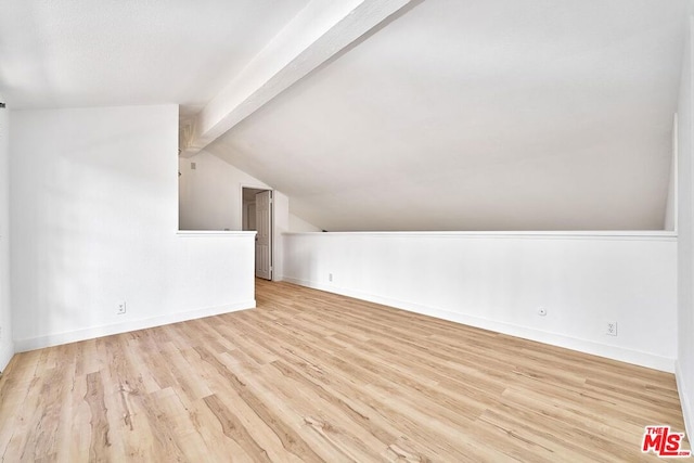 additional living space featuring lofted ceiling with beams and light hardwood / wood-style floors