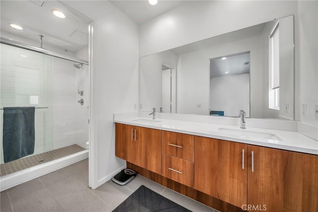 bathroom featuring tile patterned flooring, vanity, an enclosed shower, and toilet