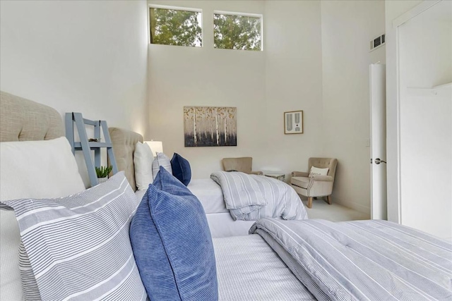 bedroom featuring a towering ceiling