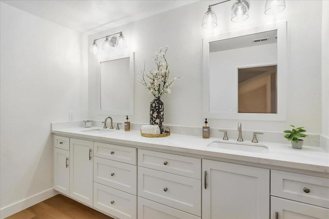 bathroom with vanity and hardwood / wood-style floors