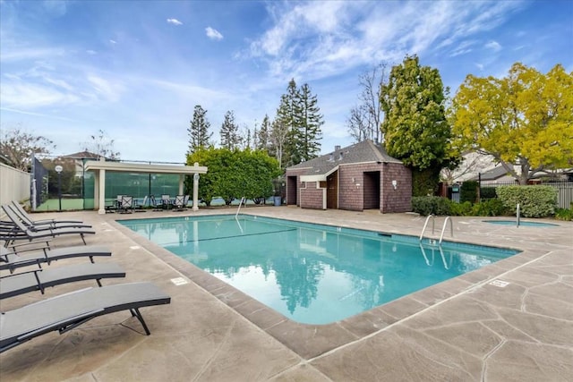 view of swimming pool featuring a patio area and an outdoor structure