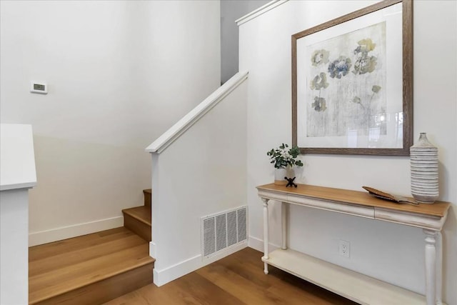 stairs featuring wood-type flooring