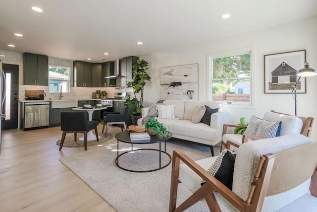 living room with sink and light hardwood / wood-style floors