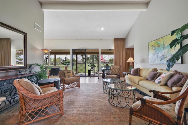 living room featuring beamed ceiling and high vaulted ceiling