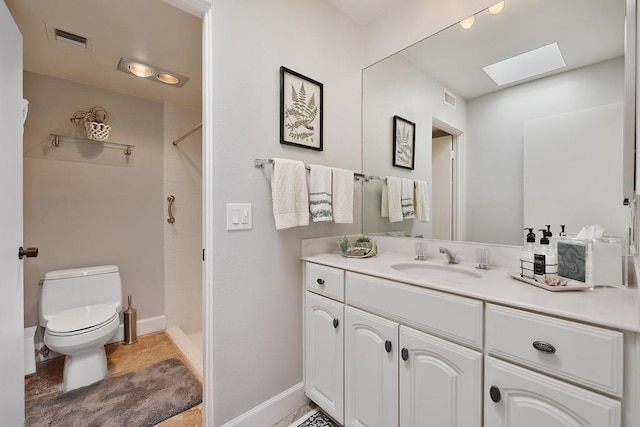 bathroom with a skylight, tile patterned flooring, vanity, walk in shower, and toilet