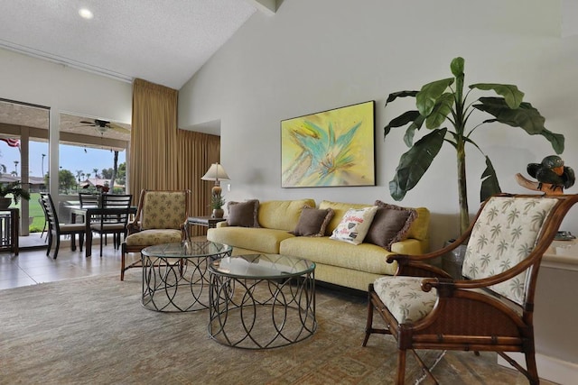 tiled living room featuring ceiling fan and high vaulted ceiling