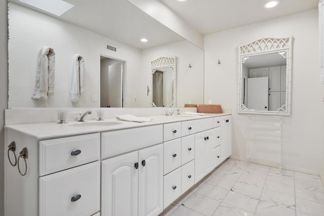 bathroom with vanity and a skylight