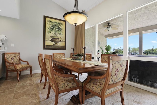 dining room featuring ceiling fan and lofted ceiling