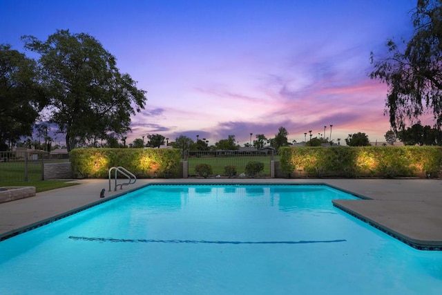 view of pool at dusk