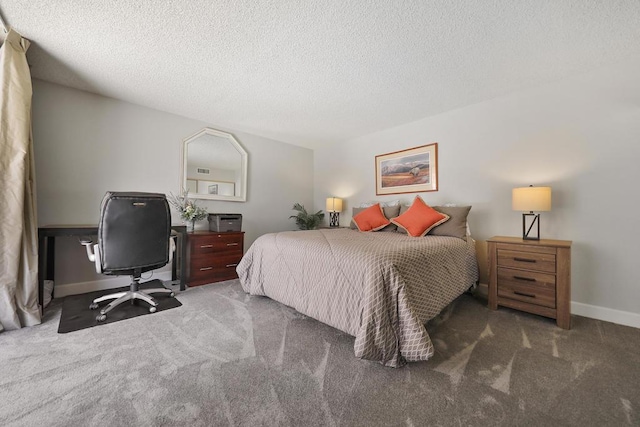 bedroom with dark carpet and a textured ceiling