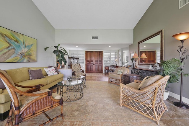 living room featuring high vaulted ceiling