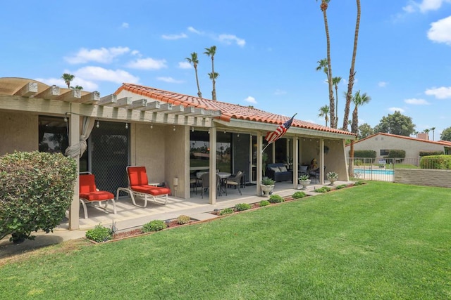 back of property featuring a patio, a yard, and a pergola