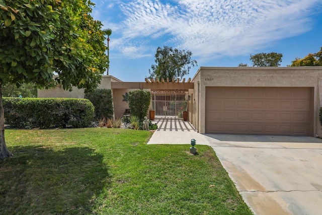 pueblo-style home featuring a garage and a front lawn