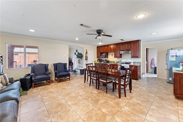 dining area featuring crown molding, ceiling fan, and light tile patterned floors