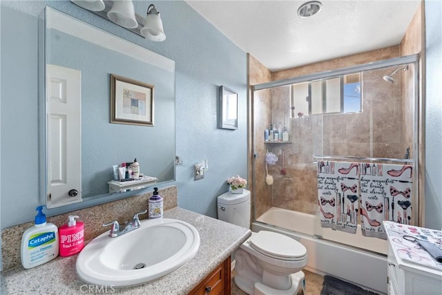 full bathroom featuring vanity, enclosed tub / shower combo, and toilet