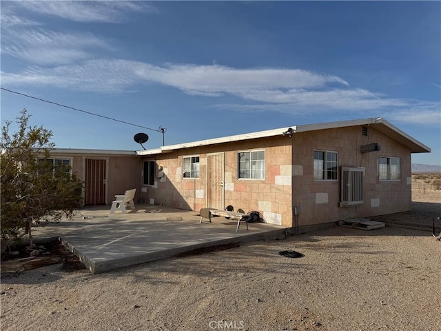 back of property with a patio area and central air condition unit