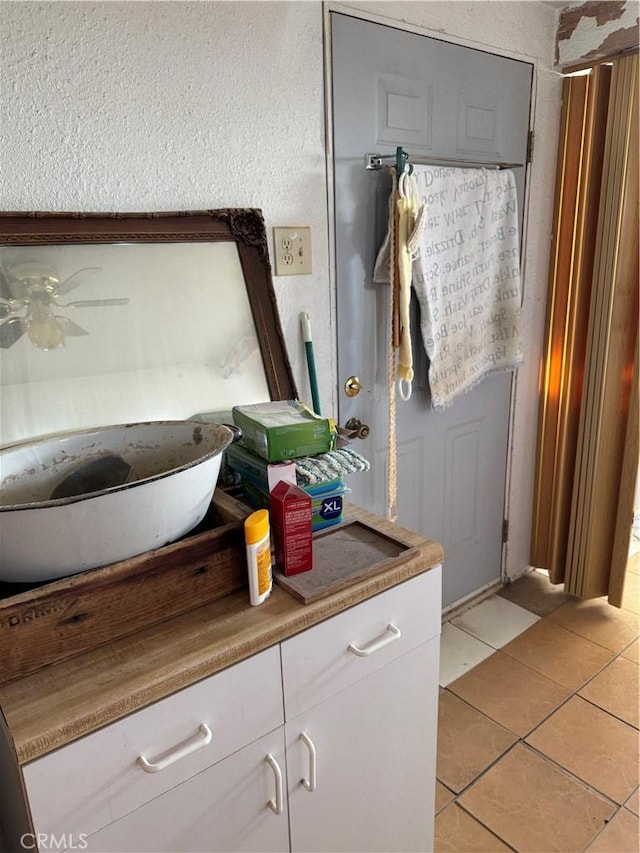 bathroom featuring ceiling fan, tile patterned floors, and vanity