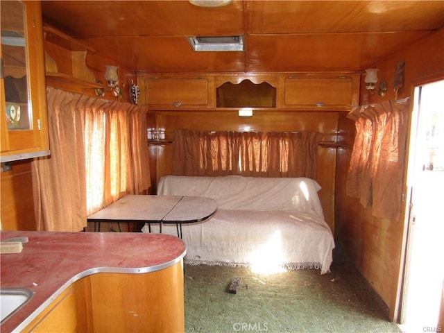 unfurnished bedroom with breakfast area and carpet