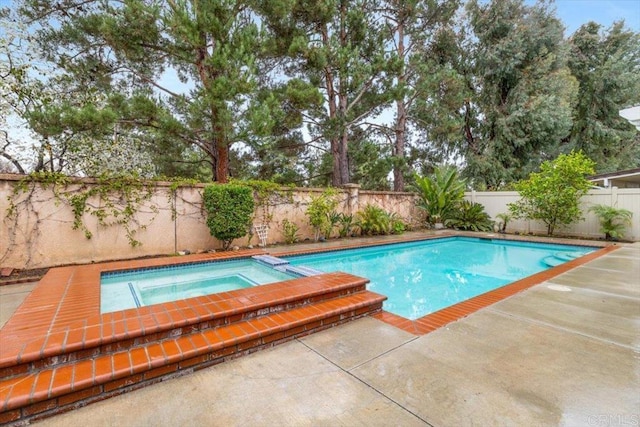 view of swimming pool featuring a patio area, a fenced backyard, and a pool with connected hot tub