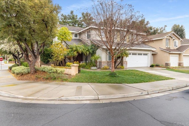 view of front of house featuring driveway, a garage, and stucco siding