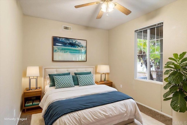 bedroom featuring baseboards, multiple windows, visible vents, and carpet flooring