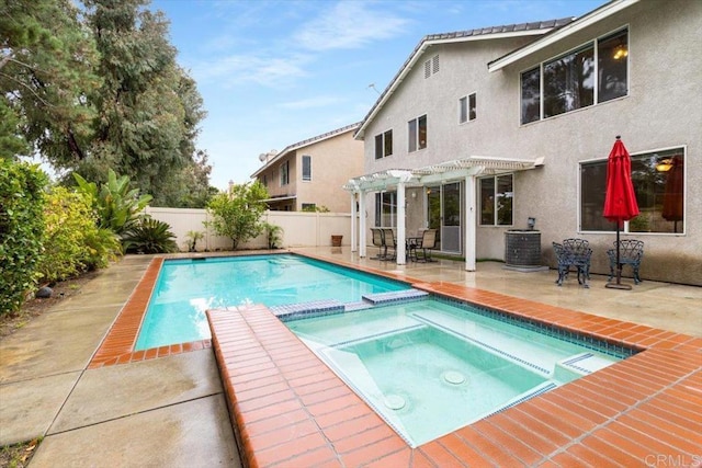 view of swimming pool with a fenced backyard, a pool with connected hot tub, a pergola, and a patio