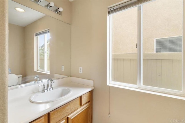 bathroom featuring toilet and vanity