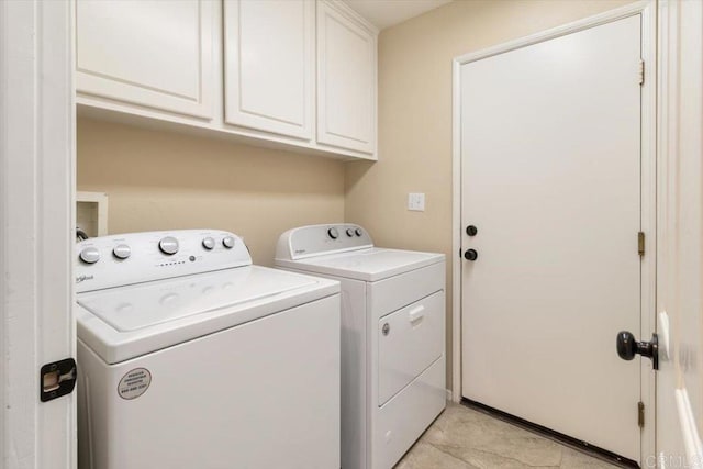 laundry room with cabinet space and washer and clothes dryer