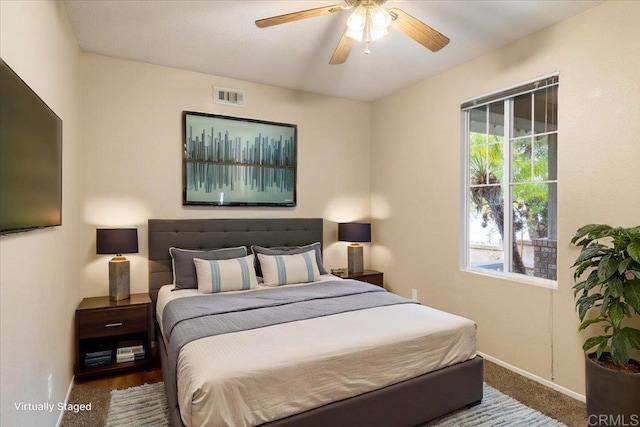 bedroom featuring baseboards, visible vents, ceiling fan, and carpet flooring