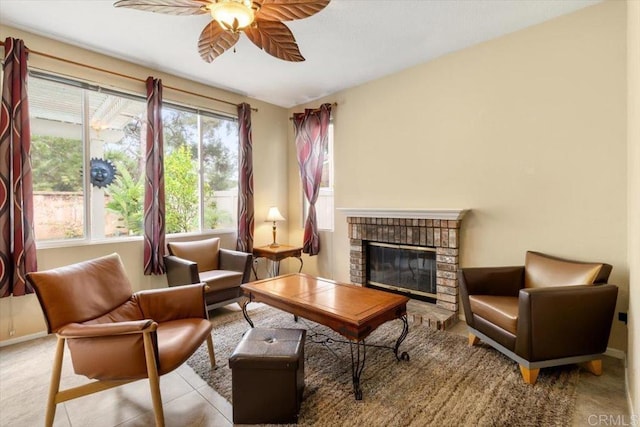 living area with ceiling fan, light tile patterned floors, a fireplace, and baseboards