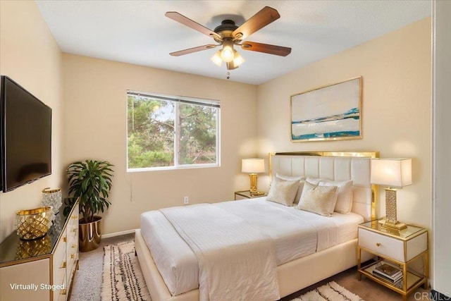 bedroom featuring ceiling fan, baseboards, and light colored carpet