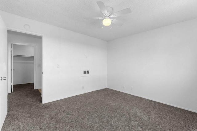 carpeted spare room featuring a textured ceiling and ceiling fan