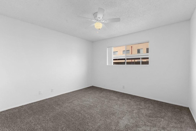 spare room with ceiling fan, carpet flooring, and a textured ceiling