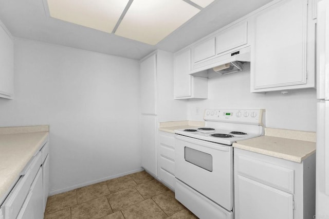 kitchen featuring light tile patterned floors, white cabinets, and white range with electric cooktop