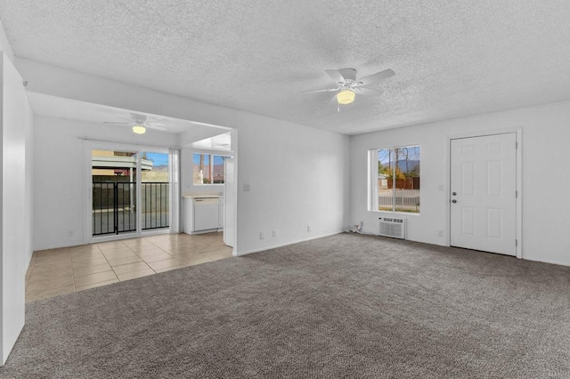 unfurnished living room with ceiling fan, light colored carpet, a textured ceiling, and an AC wall unit