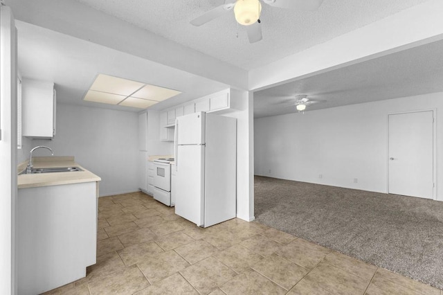 kitchen featuring sink, white appliances, ceiling fan, white cabinets, and light colored carpet