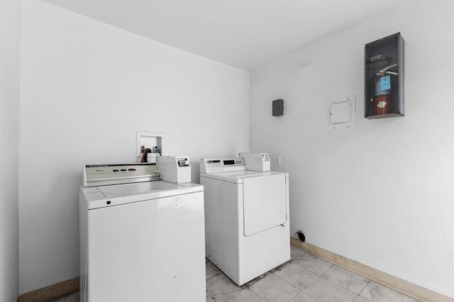 washroom featuring light tile patterned flooring and separate washer and dryer