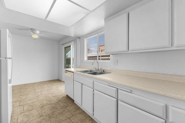 kitchen featuring light tile patterned flooring, sink, white appliances, ceiling fan, and white cabinets