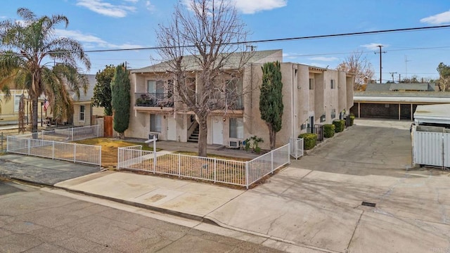 233 N Inez St, Hemet, CA 92543 - view of front of property with a gate, stucco siding, a fenced front yard, and stairs