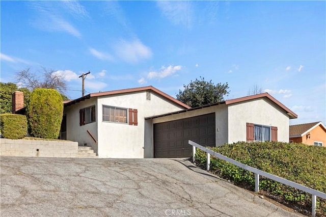 ranch-style house featuring a garage