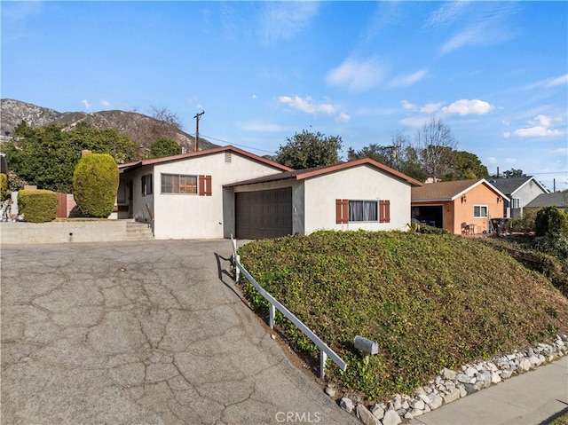 single story home featuring a garage and a mountain view