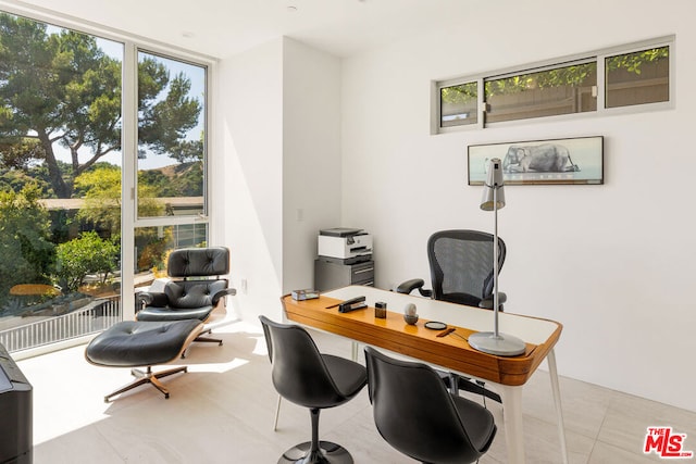 office space featuring a wall of windows and light tile patterned flooring