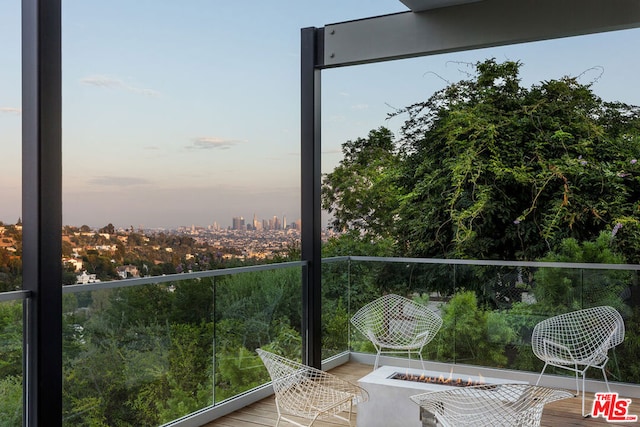 balcony at dusk with an outdoor fire pit